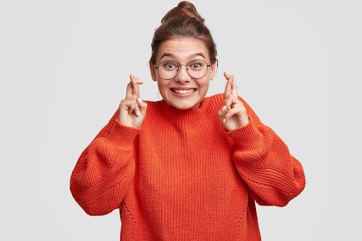 Image of woman crossing her fingers